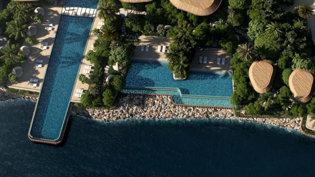 Jumeirah Asora Bay Ocean Mansion | Seafront Luxury Estate Aerial view of Ocean Mansion at Jumeirah Asora Bay featuring tiered infinity pools, lush landscaping, and direct access to the Arabian Gulf shoreline.